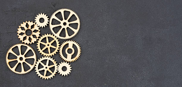 istock Wooden cogwheels on black background 2222277009