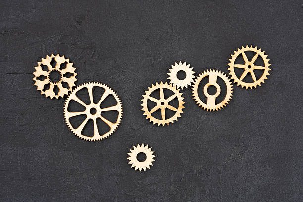 istock Wooden cogwheels on black background 2222277017