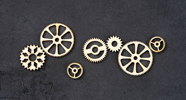 istock Wooden cogwheels on black background 2222277019