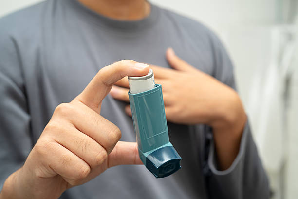 istock Asthma and chronic obstructive pulmonary disease COPD, Asian young man using metered dose inhaler MDI. 2222278041