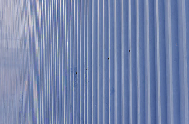 istock Dynamic Periwinkle Blue Corrugated Metal Siding Creating a Striking Abstract Backdrop of Geometric Vertical Lines and Industrial Design 2222278556