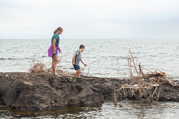 istock Two Kids On Rocks in Lake Superior 2222282915