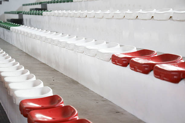 sports facility with white stands with red seats