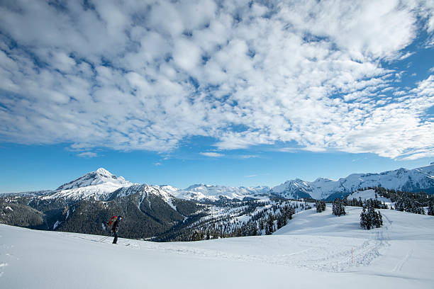 istock Distant view of backcountry skier ascending mountain 2222288316