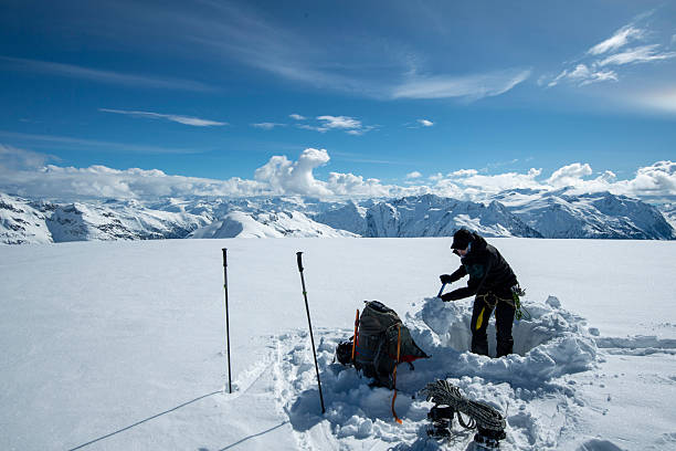 istock Backcountry skier digs snow pit on mountain top 2222289325