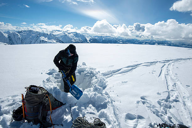istock Backcountry skier digs snow pit on mountain top 2222289329