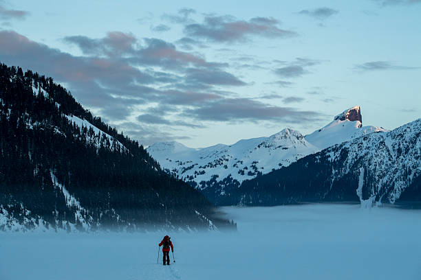 istock Backcountry splitboarder ascends mountain at dusk 2222289561