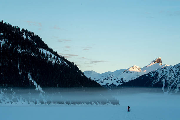 istock Backcountry splitboarder ascends mountain at dusk 2222289568