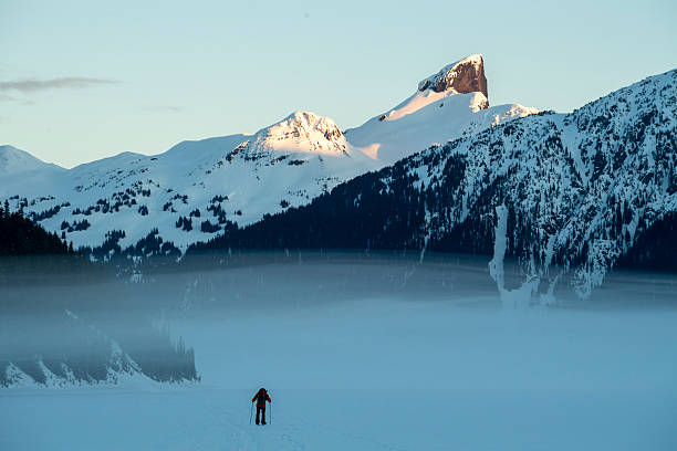 istock Backcountry splitboarder ascends mountain at dusk 2222289574