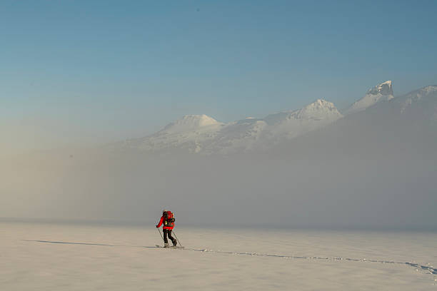 istock Backcountry splitboarder ascends mountain at dusk 2222289628
