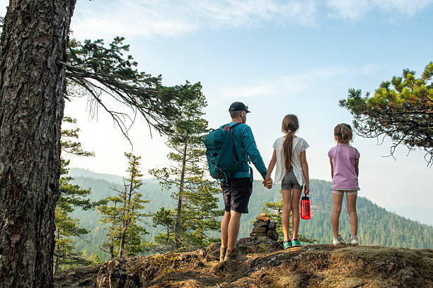 istock Father and young daughters hike in forest 2222290396