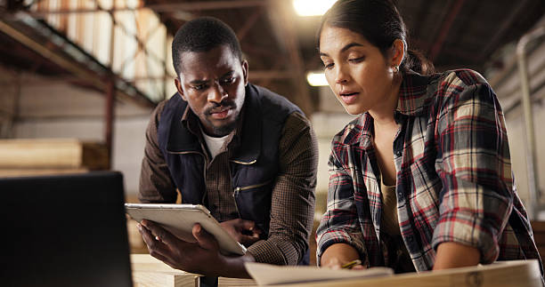 istock Carpenter, people and team with tablet, planning and research for craftsmanship in workshop or online. Collaboration, creative and sketching for furniture design, woman and man with tech for business 2222290562