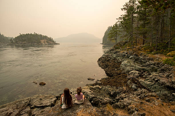 istock Young girl balances on log 2222290794