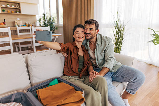 istock Happy couple taking a selfie before leaving for vacation 2222291892