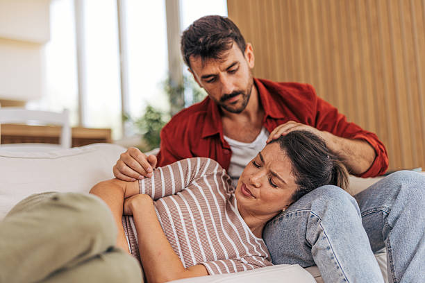 istock Man comforting his sad and depressed girlfriend lying on his legs 2222292064