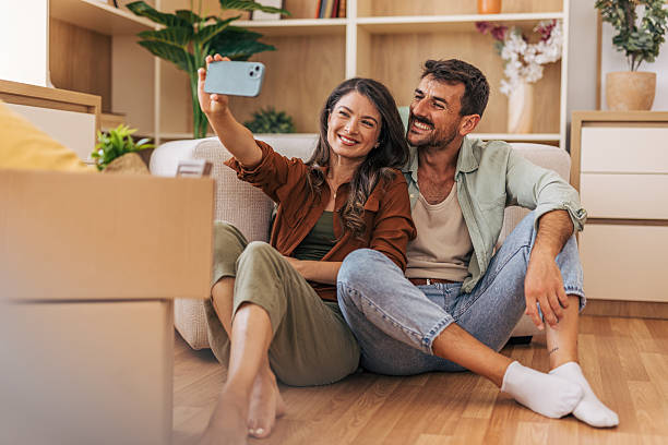 istock Happy couple taking a selfie while moving into new home 2222292486