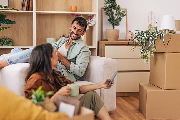 istock Couple relaxing on sofa after moving into new home 2222292665