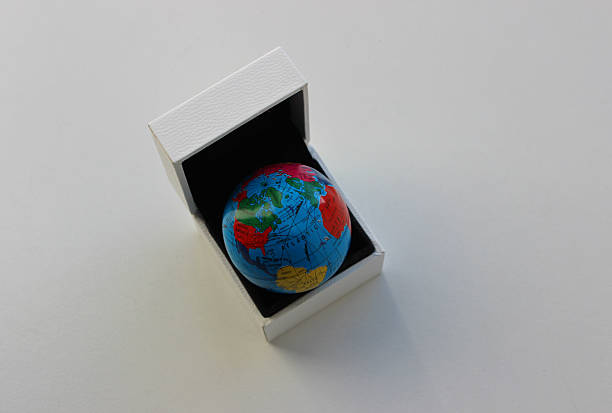 istock Continents Around the Atlantic Ocean are Mapped on a Globe in White Gift Box 2222293704