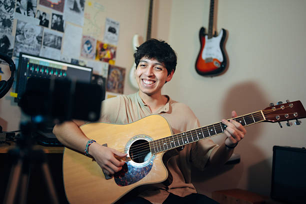 istock Young musician streaming live acoustic guitar performance 2222293807