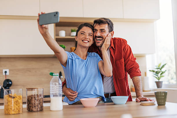 istock Happy couple taking a selfie while having breakfast in the kitchen 2222294088