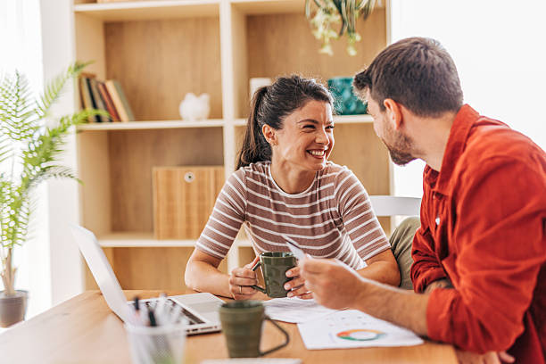 istock Young couple doing finances and smiling at home 2222294551