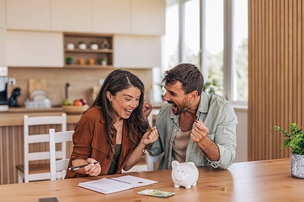 istock Happy couple celebrating financial success at home 2222294792