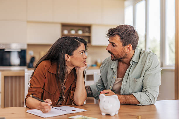 istock Young couple budgeting and saving money at home 2222294856