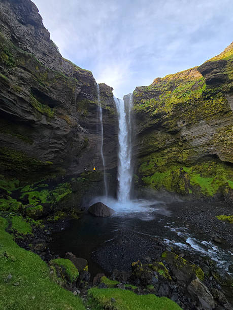 istock Kvernufoss waterfalls cascading into a serene pool surrounded by lush greenery in Iceland landscapes 2222295134