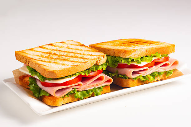 istock Club sandwich with ham, cheese, tomato and lettuce 2222295614