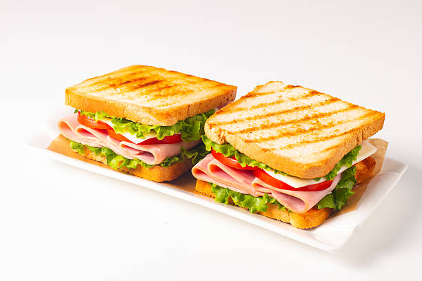 istock Club sandwich with ham, cheese, tomato and lettuce 2222295782