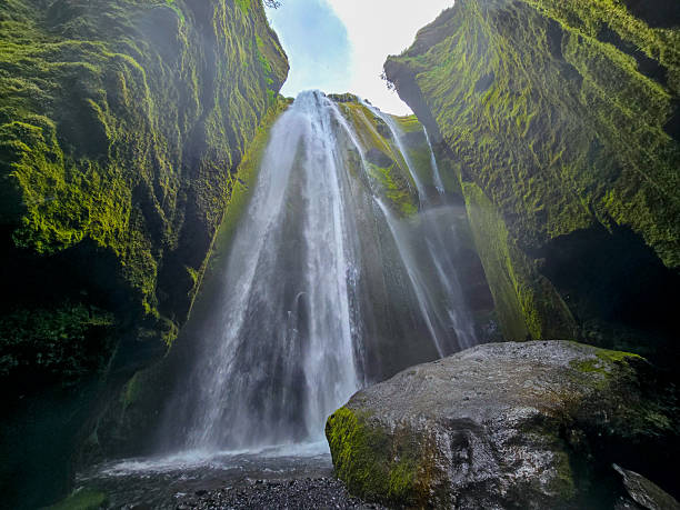 istock Majestic waterfall cascades down moss-covered cliffs in Iceland 2222296101