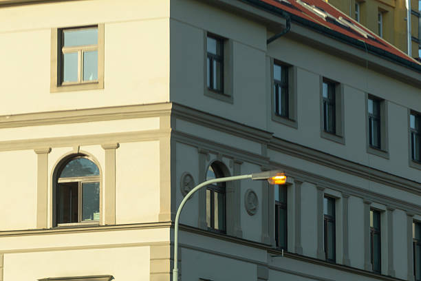 There is a notable building that has a street light located right in front of it, creating a unique urban environment and ambiance
