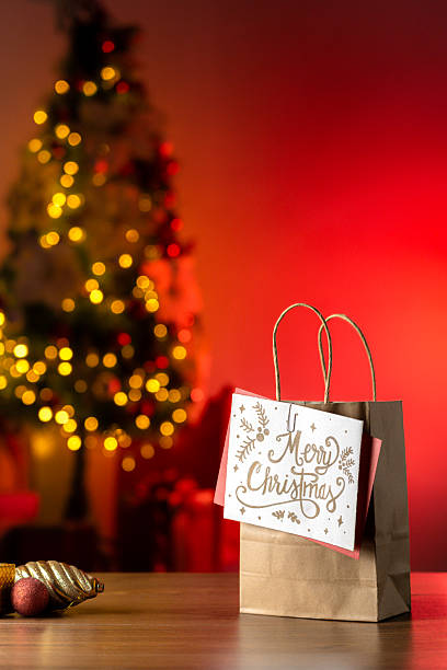 istock Christmas Shopping Bag with Greeting Card and Red Light Glow 2222302770