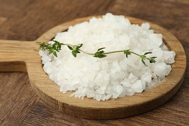 istock Sea salt and thyme on wooden table, closeup 2222303305