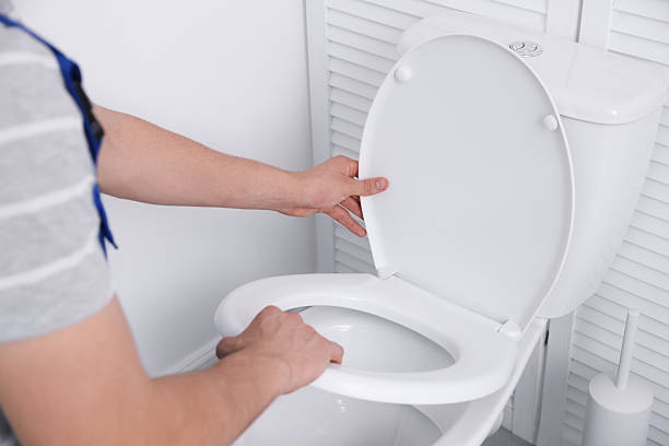 istock Man fixing toilet seat in bathroom, closeup 2222306112