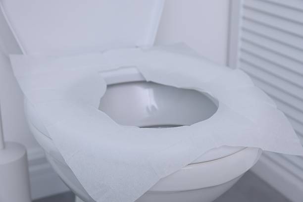 istock Toilet seat with paper tissues in bathroom 2222306130