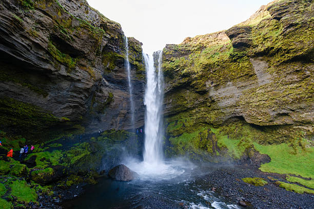 istock Visitors marvel at the stunning Kvernufoss waterfall, cascading gracefully from rocky cliffs 2222306228