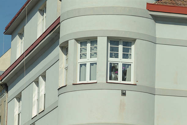 anchoring and tensioning of the tram traction network. compensation of the traction network. high voltage against the background of the facade of an old city tenement house. passenger transport in a large city