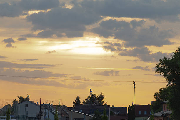 istock The bright sun is shining beautifully through the clouds over a bustling city 2222315544