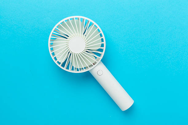 istock Mini electric fan on color background, top view 2222317185