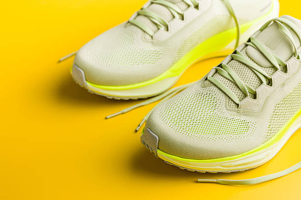 istock Sport running shoes on yellow background. 2222320656