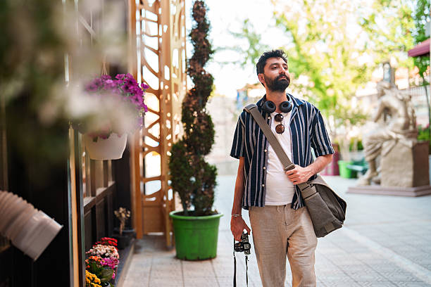 istock Exploring Souvenir Shops: Man Walking Past Gift Stores 2222322226