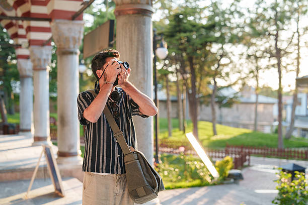 istock Capturing Islamic Architecture: Man Photographing in Front of a Mosque 2222323505