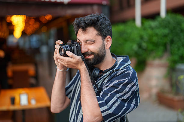istock Capturing History: Man with Camera Among Historic Homes 2222323726