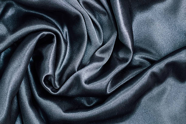 istock Luxurious dark silk fabric draped elegantly with smooth textures for fashion applications 2222326338