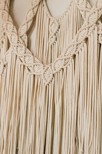 istock Macrame wall hanging displaying intricate patterns and textures in a light beige color 2222326359