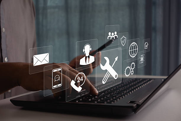 istock Businessman using laptop and smartphone for 24/7 customer support, technical assistance, and online service with digital communication icons, global technology. Concept for consulting and remote help. 2222327226