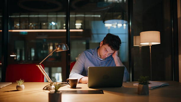 istock Overworked manager browsing laptop at night workspace. Tired businessman burnout 2222332281