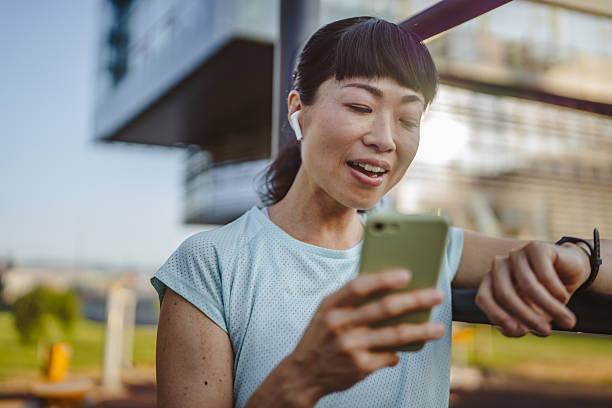 istock mature japanese sportswoman check her performance data on smart watch 2222333739