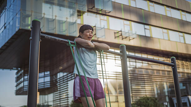 istock Tired mature japanese woman during break after pulls up on bar 2222334195